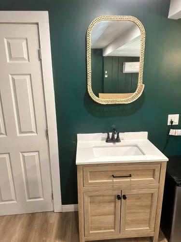 a bathroom with a sink and a mirror at COZY Studio in Downtown San Diego in San Diego