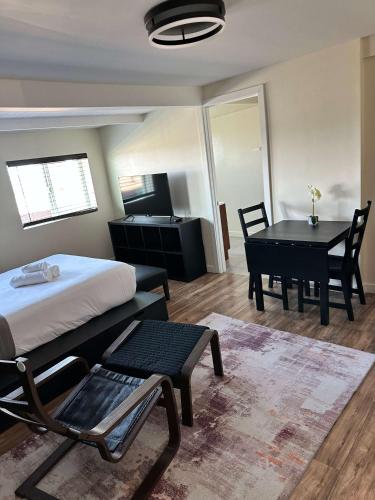 a bedroom with a bed and a table and a desk at Special Studio in Center of San Diego in San Diego