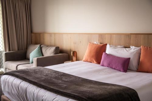 a hotel room with a bed and a couch at Nagambie Waterfront Motel in Nagambie