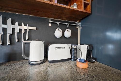a kitchen counter with a coffee maker and utensils at 55 Davey Townhouse 2, Salamanca on your doorstep in Hobart