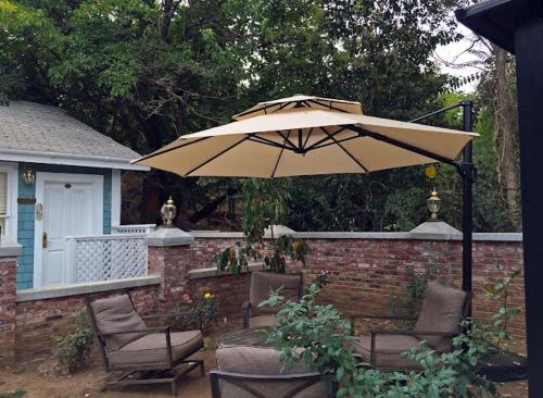 a patio with two chairs and an umbrella at Americas Best Value Inn Royal Carriage in Jamestown
