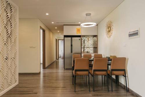 a dining room with a table and chairs at Hi-Home Suites - City view Apt in HongKong Tower in Hanoi