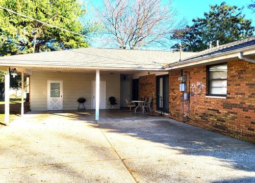 a brick house with a porch and a patio at Stacy's Retreat in Fairview Heights