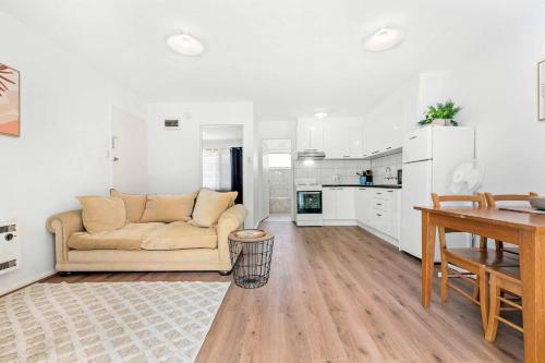 a living room with a couch and a table at Spacious 1-Bedroom Apartment with Car Space in Melbourne
