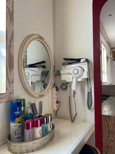 a room with a hair dryer and a mirror at Empire Motel in Cheonan