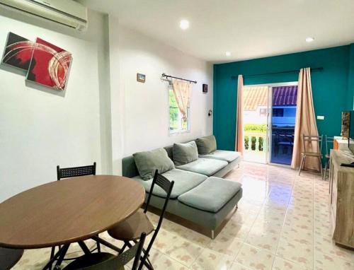 a living room with a couch and a table at 2 bedroom bungalow Nai Harn 4 Resort in Ban Suan