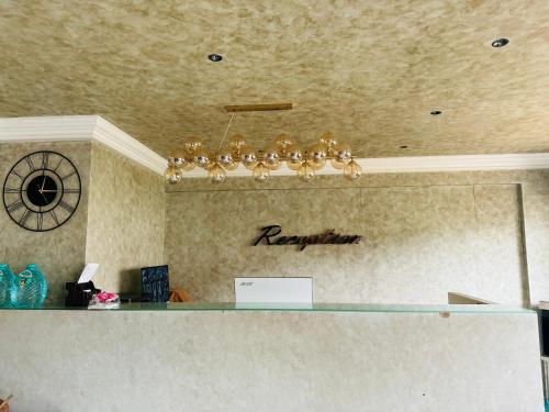 a chandelier hanging over a counter in an office at DREAMZ LUXURY HOMe in Kammasandra
