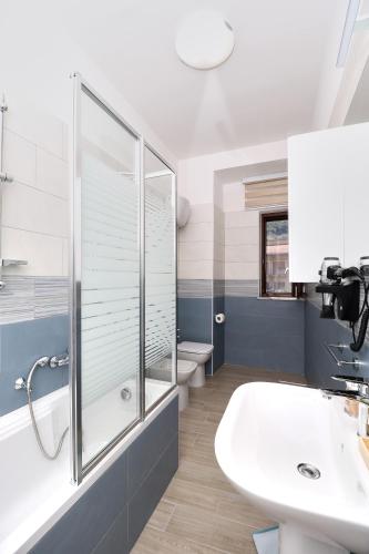 a bathroom with a sink and a shower and a toilet at Like Home in Nocera Superiore