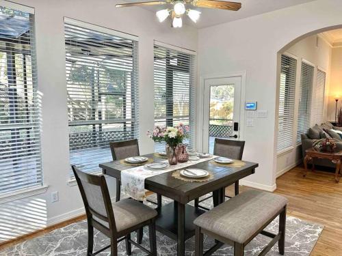 a dining room with a table and chairs and windows at Custom luxury house in Katy near I10 and 99 in Katy