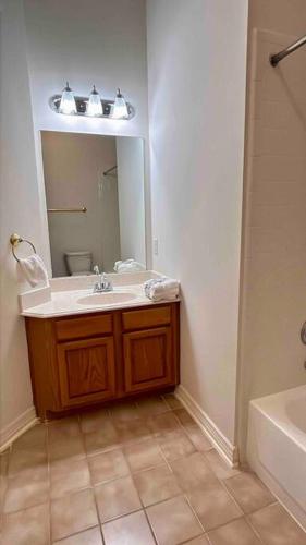 a bathroom with a sink and a mirror at Custom luxury house in Katy near I10 and 99 in Katy