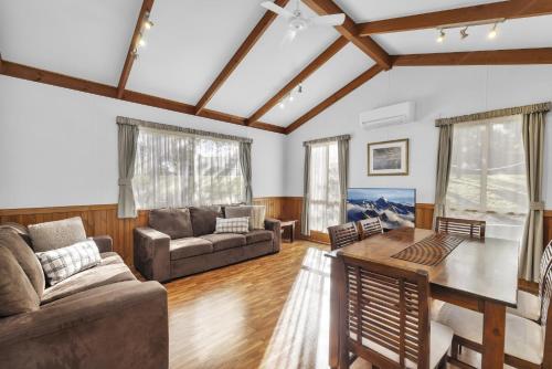 a living room with a couch and a table at Metung Holiday Villas in Metung