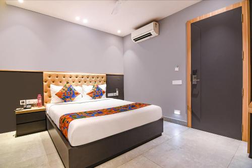 a bedroom with a large bed in a room at FabHotel Prime The Water View Residency - Nr Bisarjan Ghat in Kolkata