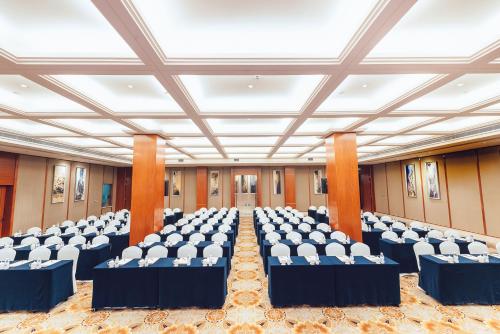 a large room with rows of chairs and tables at Grand Scent Hotel in Chengdu