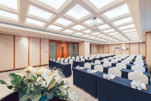 a large room with rows of tables and chairs at Grand Scent Hotel in Chengdu
