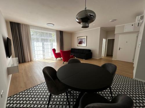 a living room with a black table and chairs at Rezidencia OPERA - Villa Bizet in Turčianske Teplice