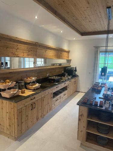 a large kitchen with wooden cabinets and a counter at Gut Mitterlehen in Elsbethen