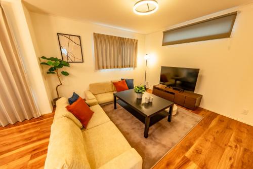 a living room with a couch and a table at HOTEL Grand Star Tokyo in Tokyo