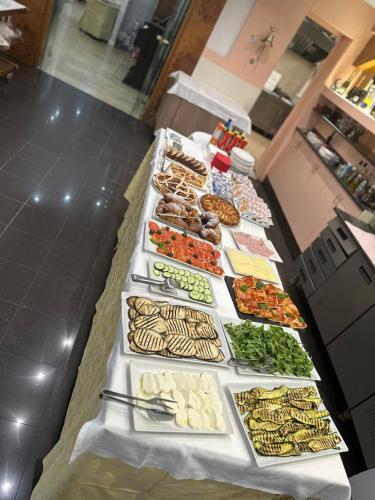 a buffet line of food on a table at Hotel Green castellani in Vicenza