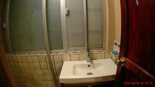 a bathroom with a sink and a shower at Hotel Casona del Truco in Guanajuato