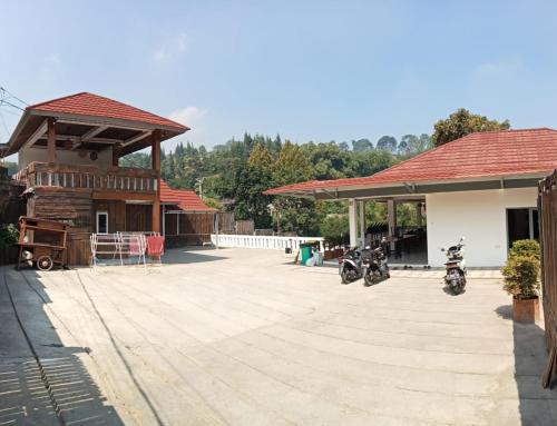 two motorcycles parked outside of a building at villa meilody 4 - Hera space in Paragajen