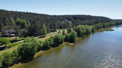 an aerial view of a river with trees and water at Pod Pługiem in Swornegacie 