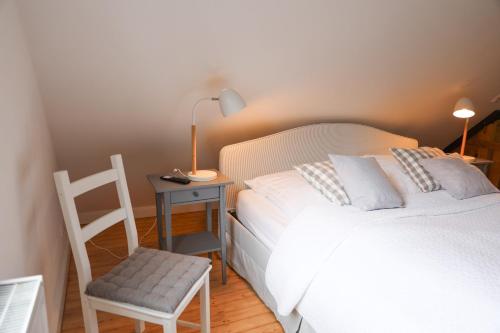 a bedroom with a bed and a chair and a desk at Gut Basthorst in Basthorst
