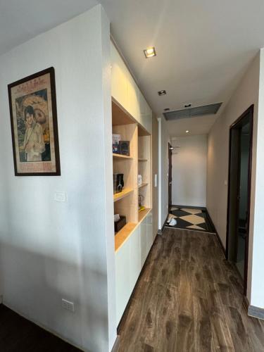 an empty hallway with a painting on the wall and a painting on the wall at W8 CONDO, TOP Floor LUXE 3 Bedroom Penthouse, Hip central Bangkok area, 5 mins from Thonglo BTS station in Bangkok