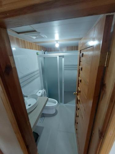 a small bathroom with a toilet and a shower at Quarrybay Hometel Sagada in Sagada