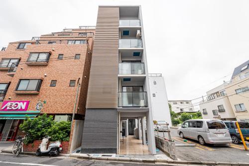 a building on a street with a scooter parked in front at New Cozy APT Located on the Japanese Local shopping street in Tokyo