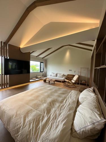 a large bedroom with a large bed and a couch at 陌上是舍uptownFARM in Chang-she-chen