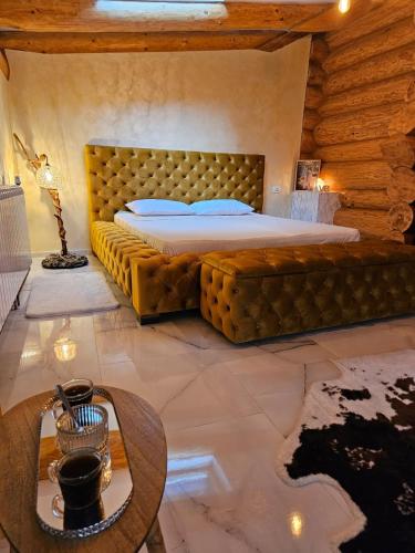 a bedroom with a bed in a room with a table at Cabana Ursilor in Vama