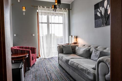 a living room with a couch and a window at Biała Koszula in Tleń