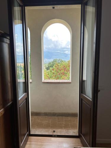 an open door with a window in a room at AGRITURISMO LA CORTE DEI CAVALIERI in Montefalco