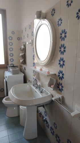 a bathroom with a sink and a toilet and a window at Blu Armony in Sirmione