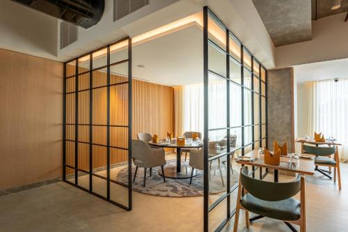 a dining room with a table and chairs at Park Inn by Radisson Vellore in Vellore