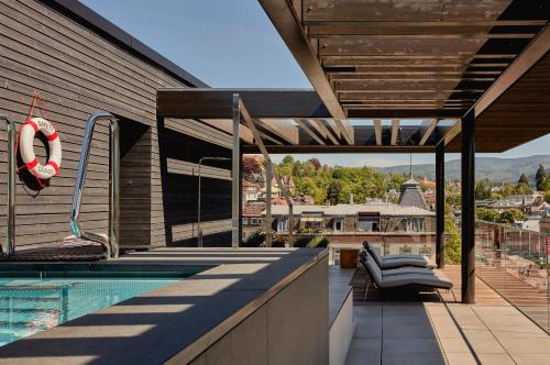 a swimming pool on the roof of a house at Roomers Baden-Baden, Autograph Collection in Baden-Baden