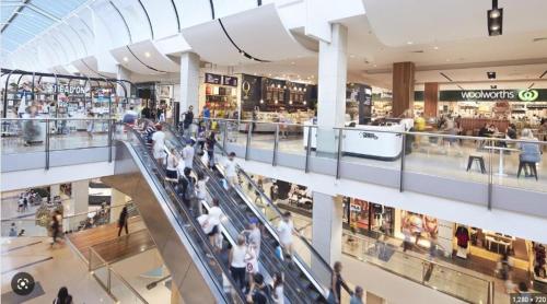 a large shopping mall with a lot of people in it at studio near Airpot Bay City in Sydney