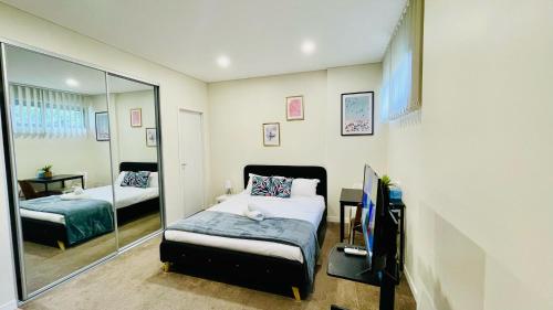 a bedroom with two beds and a mirror at studio near Airpot Bay City in Sydney
