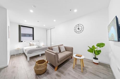 a living room with a couch and a bed at Burwood 1Br apt nearTrainShopping street parking in Sydney