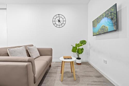 a living room with a couch and a table at Burwood 1Br apt nearTrainShopping street parking in Sydney