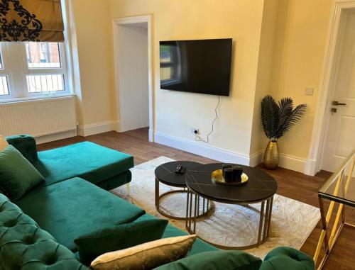 a living room with a couch and a table at 3 Bed - Sleeps 7 - Free Parking - Central Location in Glasgow