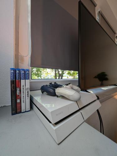 a table with books and a tv on top of it at Privatunterkunft in Göppingen in Göppingen