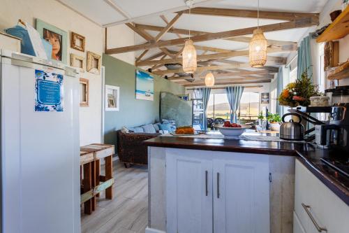 a kitchen with white cabinets and a living room at Mountain Bliss at Reebok Rus in Reebok