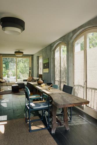 a dining room with a wooden table and chairs at La Bolla Verde Lake Como in Lecco