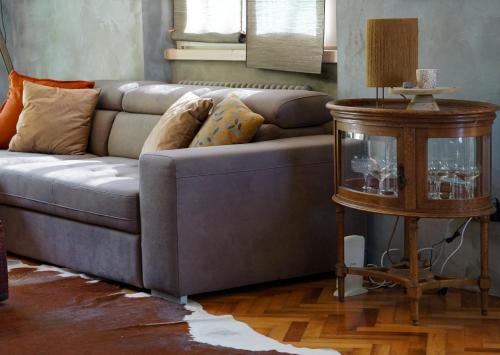 a living room with a couch and a table at La Bolla Verde Lake Como in Lecco