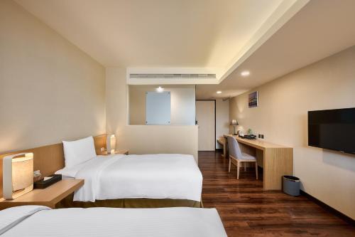 Ένα ή περισσότερα κρεβάτια σε δωμάτιο στο Eastin Taipei Hotel