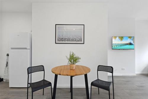 a table with two chairs and a plant on it at Burwood 1Br studio nearTrain StationShopping in Sydney