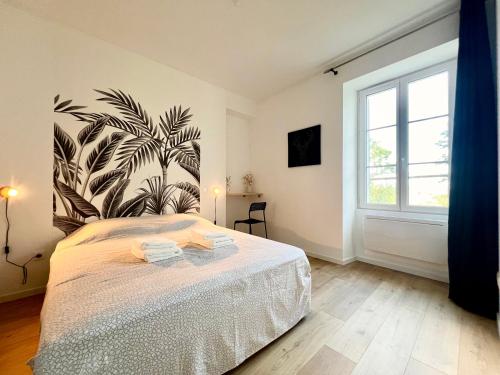a bedroom with a bed and a large window at La parenthèse Pictave - centre-ville de Poitiers in Biard