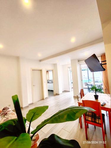 a living room with a table and a dining room at Seixal Bay Village - Family Choice in Seixal