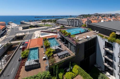 an aerial view of a building with a swimming pool at Savoy Insular I by An Island Apart in Funchal
